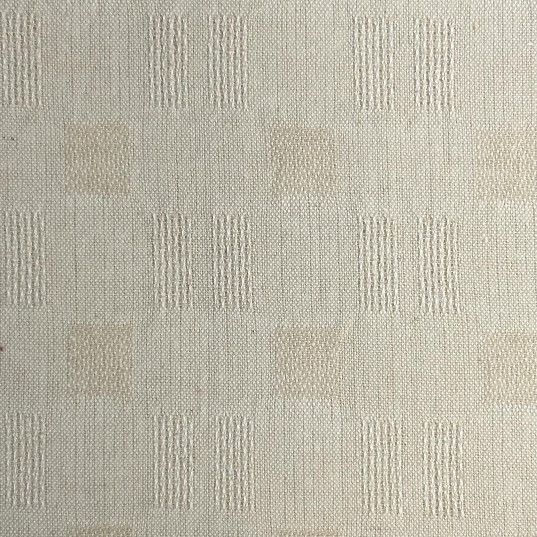 Yarn Dye Nikko Waffle 9127 Cottage Linens - A close-up view of a textured beige fabric with a pattern of vertical and horizontal lines.