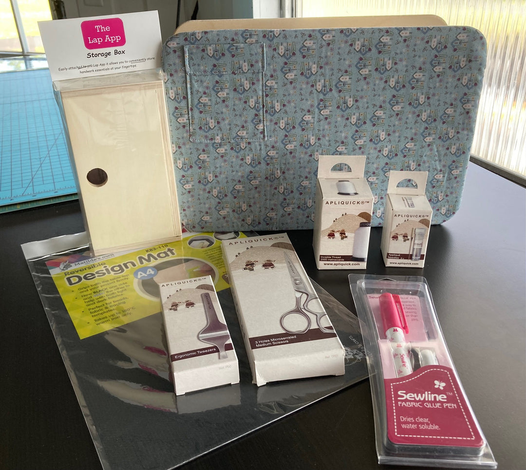 Lap App, Lap App Storage Box, Design Mat (8 1/2" x 11"), Medium Apliquick Scissors, Apliquick Invisible Thread, Apliquick Machine Applique Needles, Sewline Glue Pen, and Apliquick Tweezers
