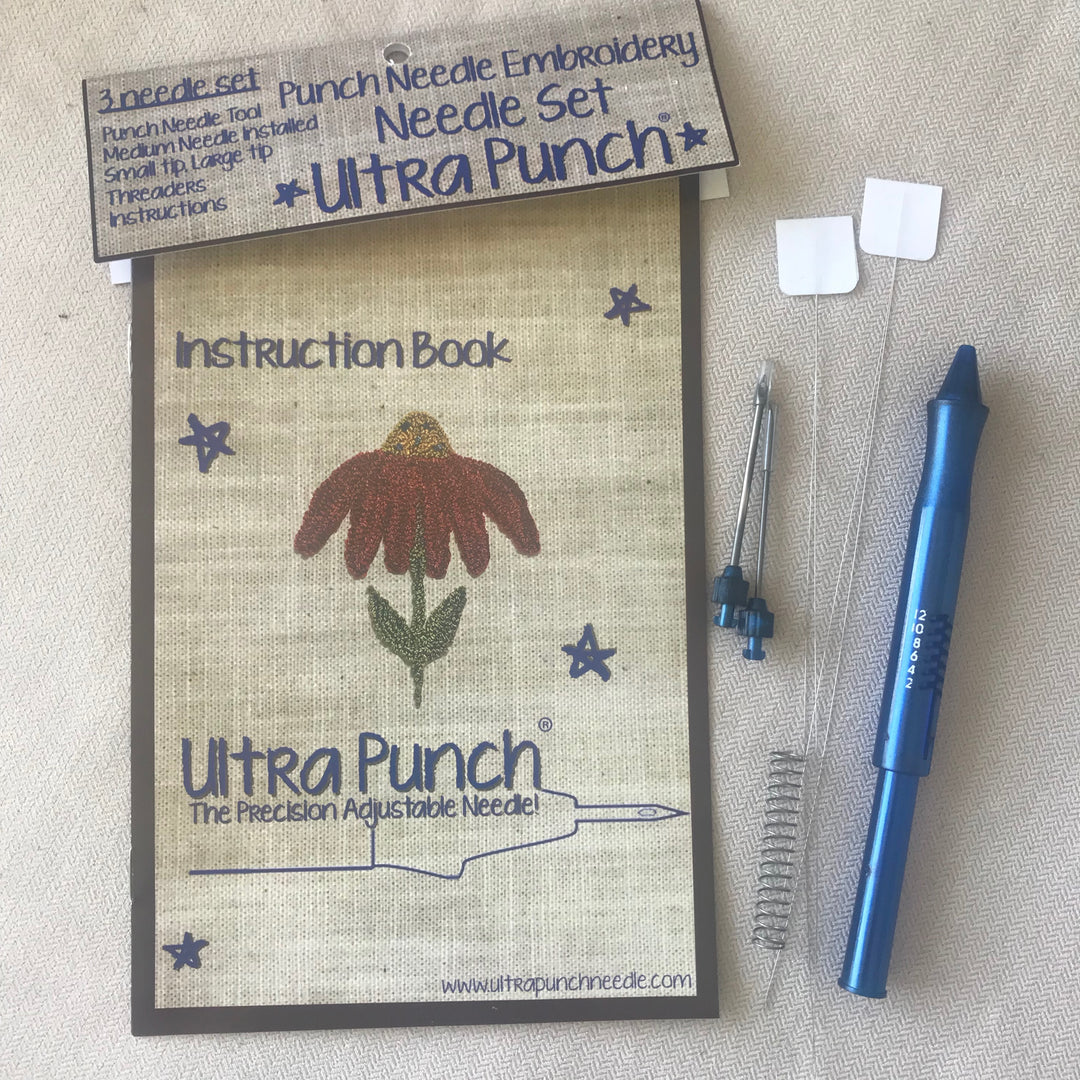 A punchneedle embroidery needle set with three needles, a needle threader, and an instruction book.