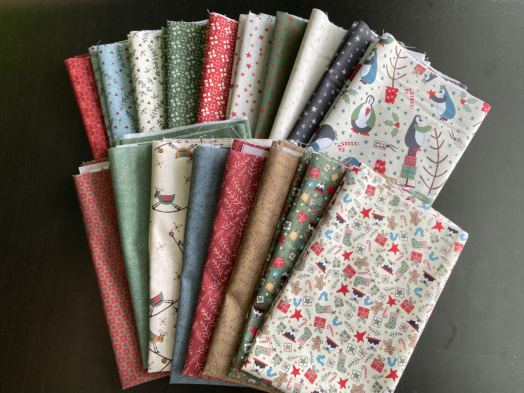 A selection of fabric pieces from the Three Wise Penguins collection, featuring various patterns including penguins, birds, and Christmas-themed prints.