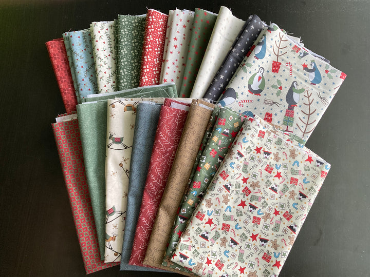 A selection of fabric pieces from the Three Wise Penguins collection, featuring various patterns including penguins, birds, and Christmas-themed prints.